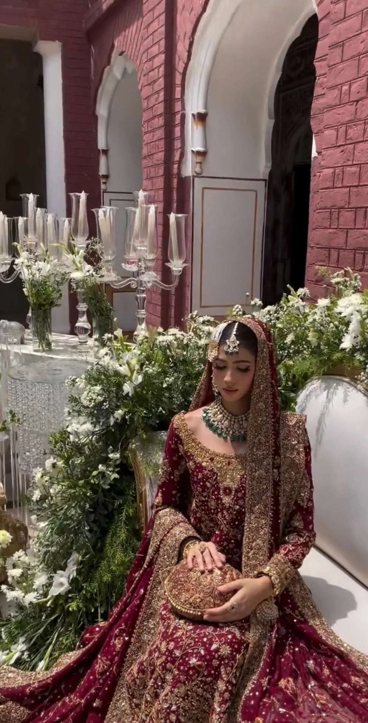Haris Shakeel Ishq Series bridal ensemble in deep romantic maroon featuring intricate adda work and hand embellishment with fine dabka and handworked motifs spread generously across the shirt, sleeves, and flowing lehenga with richly embellished borders, paired with a heavily worked dupatta with ornate edging, perfect for brides seeking classic sophistication and traditional grandeur.