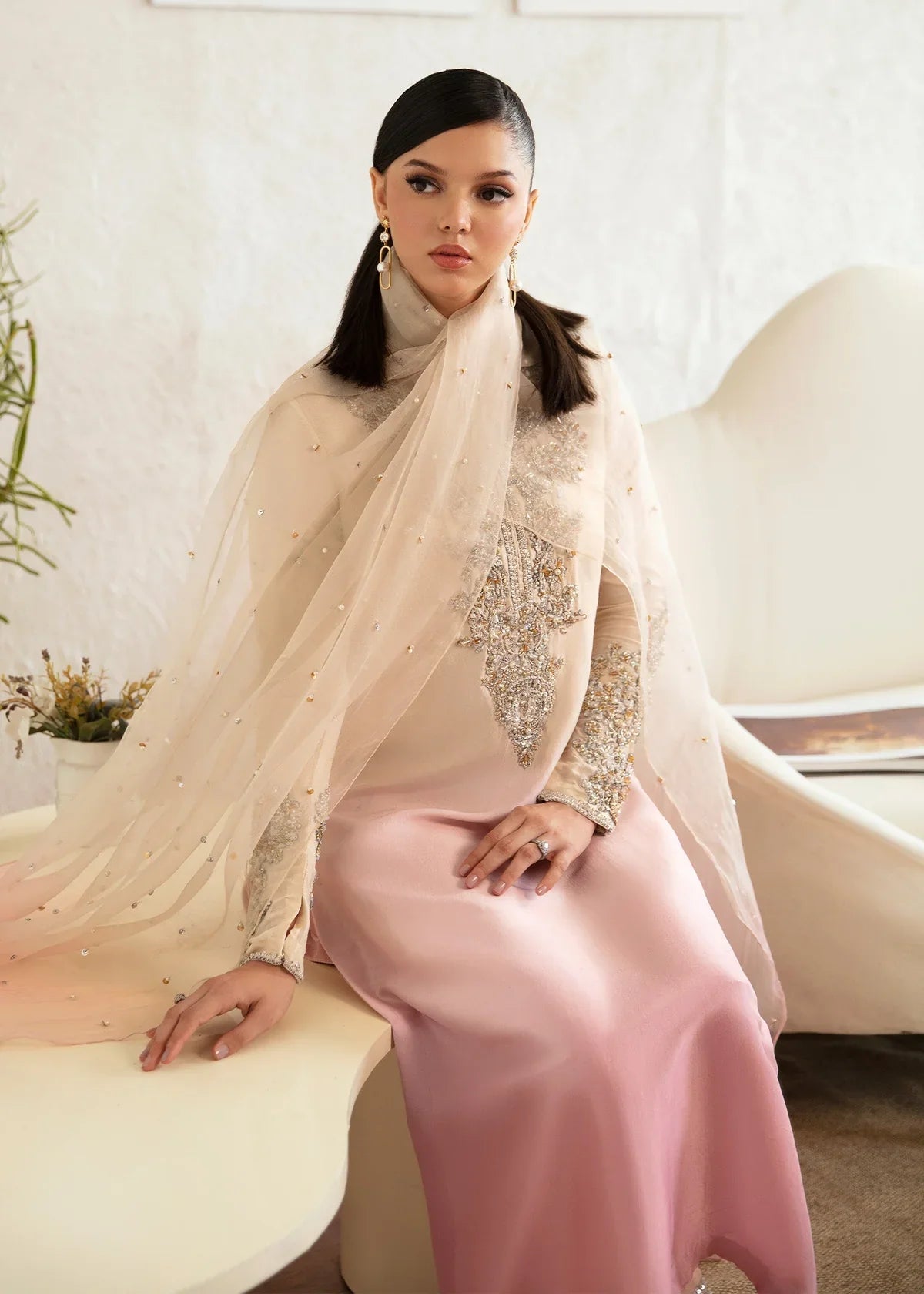 Maura ombre pink Pakistani designer formal ensemble featuring a pure raw silk shirt with intricate hand embellishments, paired with matching raw silk culottes and an organza dupatta with celestial accents, creating a glamorous and sophisticated look for formal events and weddings.