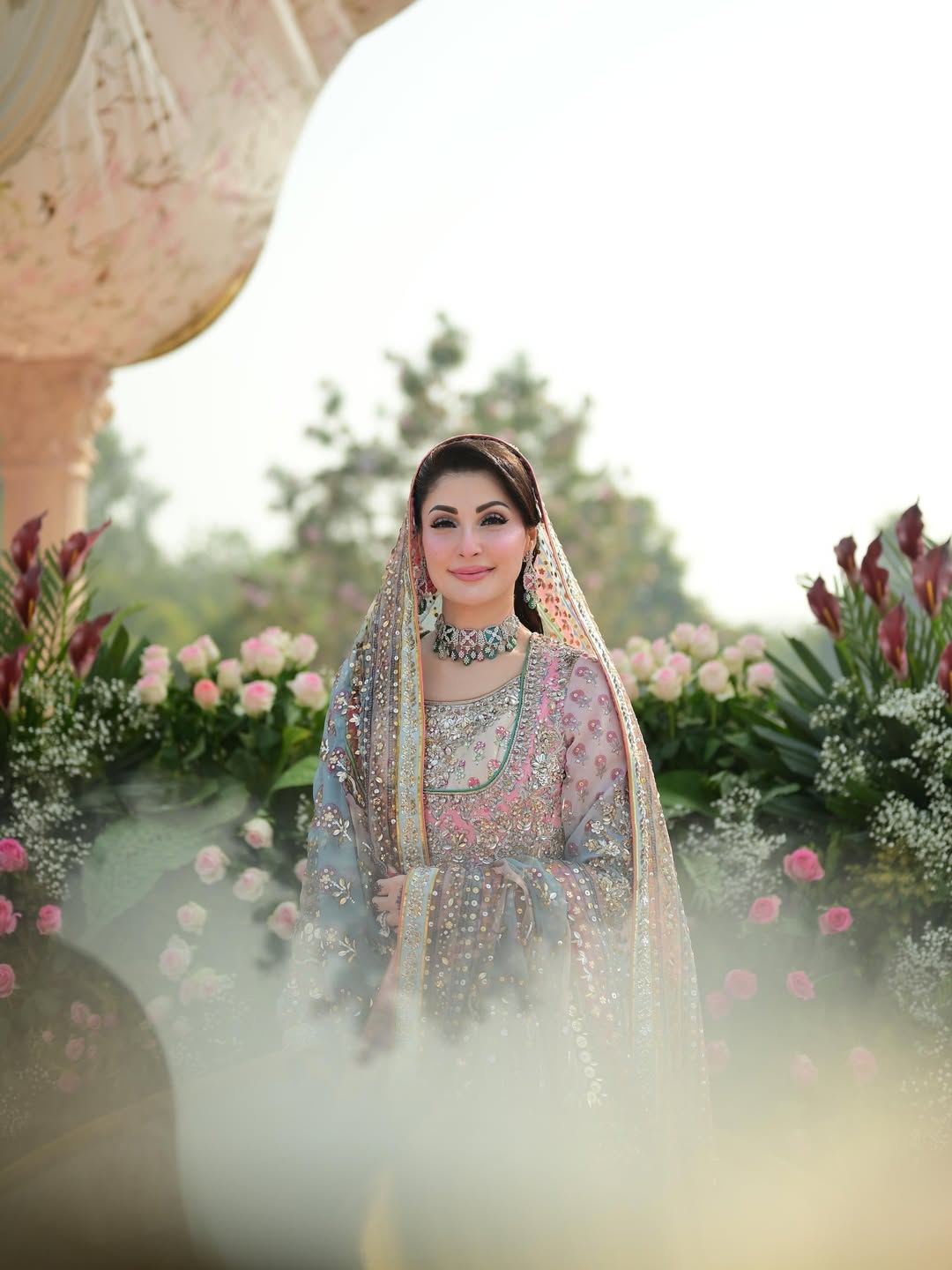 Nomi Ansari pastel princess-style lehenga choli inspired by Maryam Nawaz viral wedding look in soft blush pink and mint tones layered over a powder base, featuring delicate handcrafted embellishments with a floaty lightweight dupatta that creates a dreamy silhouette, perfect for valima receptions, engagement ceremonies, and bridesmaids