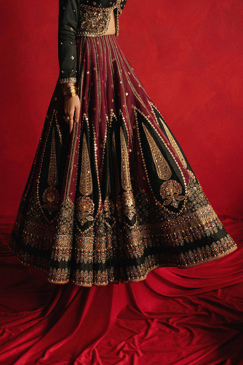 Mohsin Naveed Ranjha Dil Raas black Indian silk lehenga choli featuring a full-sleeved choli with metallic and silk thread embroidery in star-like patterns, paired with a lehenga in deep maroon fading to black with embroidered cypress trees, palmette motifs, mirrorwork, sequins, and golden thread detailing, finished with maroon and gold layered borders, complete with a lightweight organza dupatta featuring maroon and gold floral sprays, gota pati, and adda work, perfect for bridal wear and formal celebratio