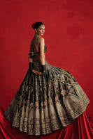 Mohsin Naveed Ranjha Gul-e-Khaas dark green Indian silk lehenga choli featuring a floral printed sleeveless choli with golden embroidery along the neckline and straps, paired with a lehenga layered with appliqués, block-printed motifs, gota patti, mirror work, hand embroidery, and spade-inspired geometric patterns with an ornate golden threadwork hemline, complete with an organza dupatta blooming with printed florals, gota patti, adda work, embroidered borders, kiran trims, and delicate tassels, perfect for