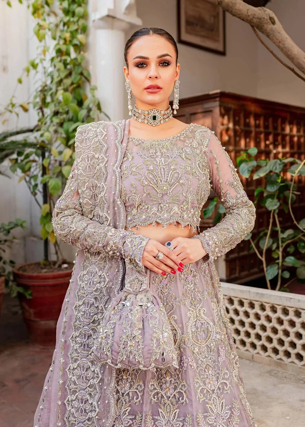 Kanwal Malik Zaarish lilac organza lehenga choli featuring heavy embroidery and hand embellishments with naqshi, dabka, crystals, pearls, and sequin in a blend of floral and geometrical patterns, paired with an organza dupatta adorned with a four-sided embellished border and vertical embellished lines at the center with extended pallu, perfect for weddings and formal occasions.
