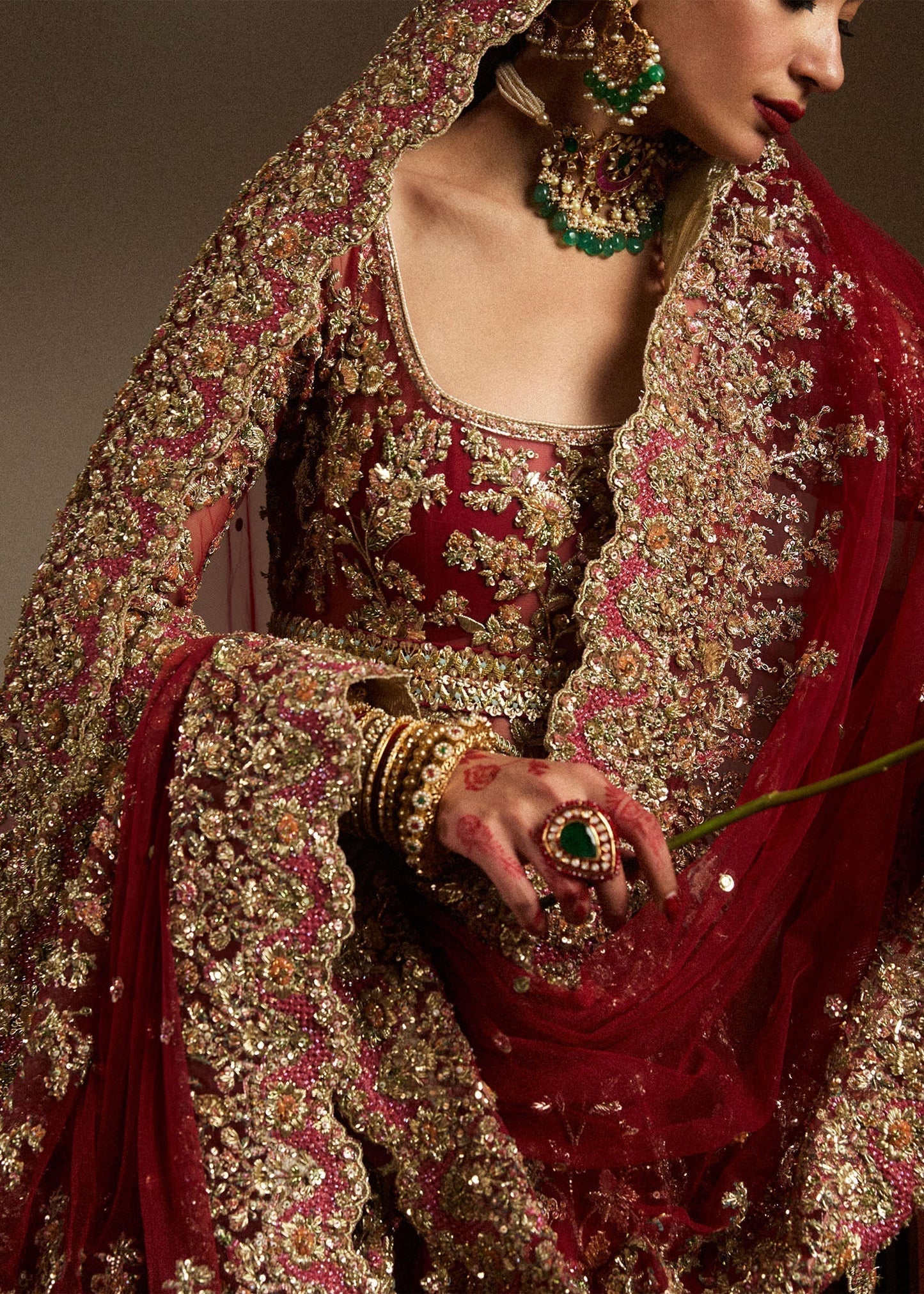 Hussain Rehar Qashqaye deep maroon lehenga choli featuring exquisite handwork that shimmers with delicate light, with a voluminous lehenga paired with an intricately worked choli, perfect for bridal wear and grand wedding celebrations.