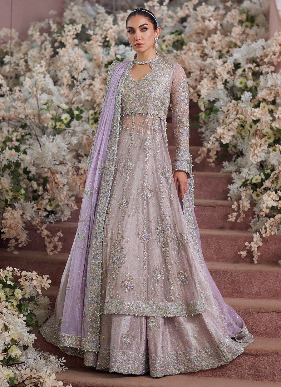 Farah Talib Aziz Elanur lilac bridal kalidaar crafted on pure net with intricate hand embellishments featuring a flared silhouette, paired with a classic lehenga and coordinated net dupatta with subtle embroidery, perfect for wedding festivities and formal celebrations.