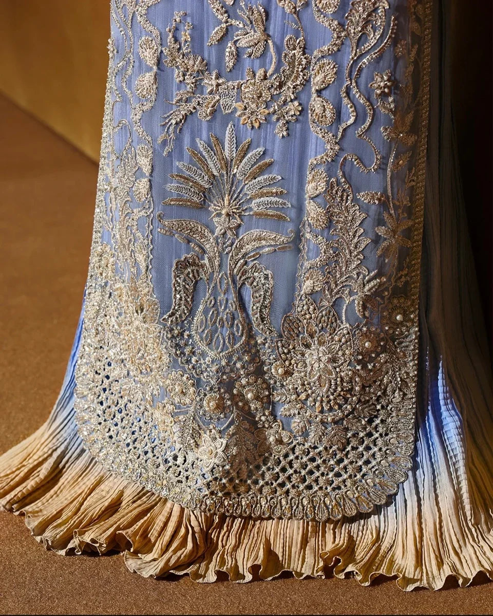 Soraya inspired Seralyn luxury formal ensemble in a soft ethereal pastel palette with subtle warm undertones featuring intricate hand embellishments and shimmering accents on a flowing silhouette with a richly worked bodice and embellished flare, paired with a coordinated dupatta with elegant borders, perfect for weddings and formal celebrations.