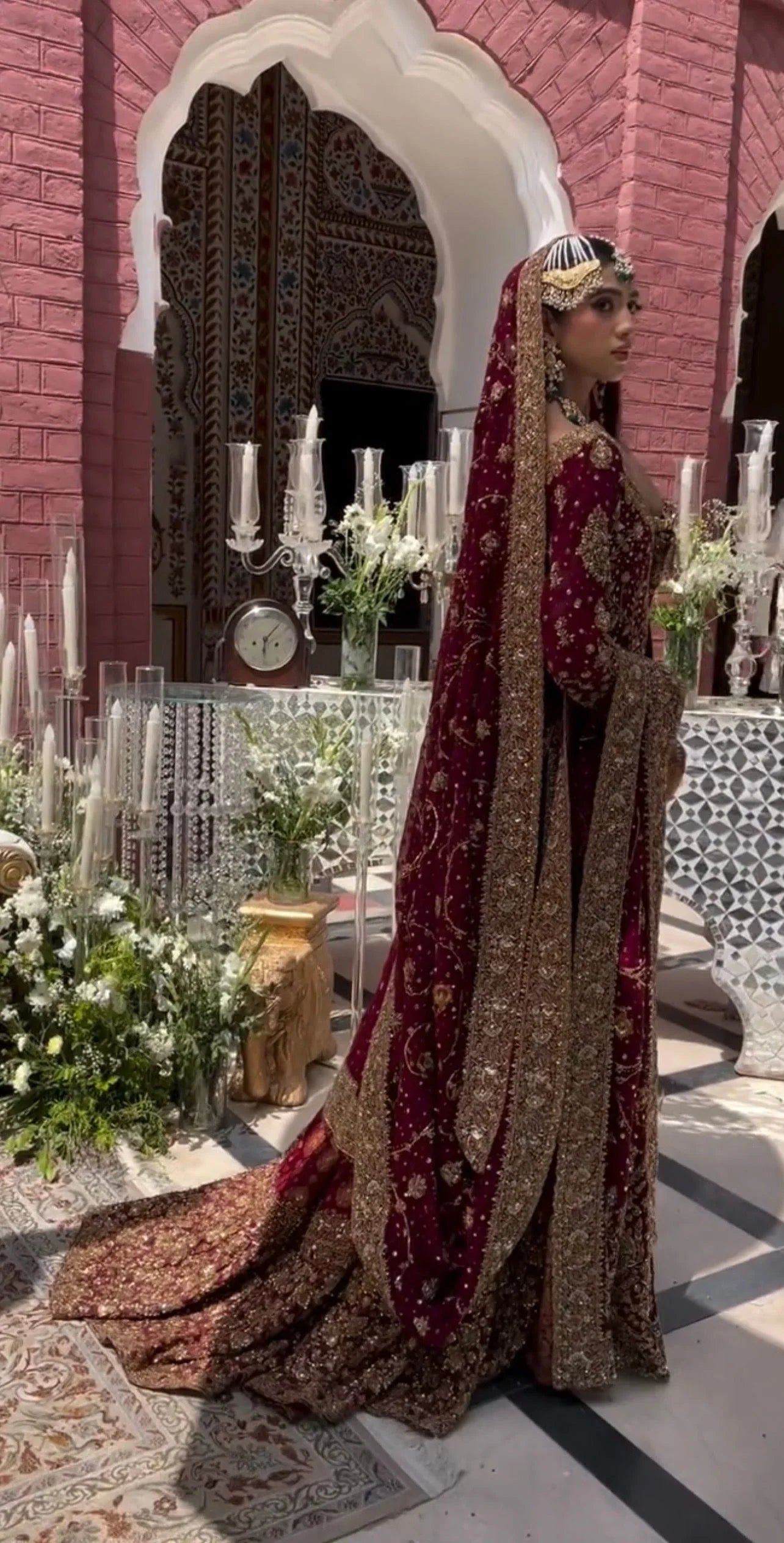 Haris Shakeel Ishq Series bridal ensemble in deep romantic maroon featuring intricate adda work and hand embellishment with fine dabka and handworked motifs spread generously across the shirt, sleeves, and flowing lehenga with richly embellished borders, paired with a heavily worked dupatta with ornate edging, perfect for brides seeking classic sophistication and traditional grandeur.