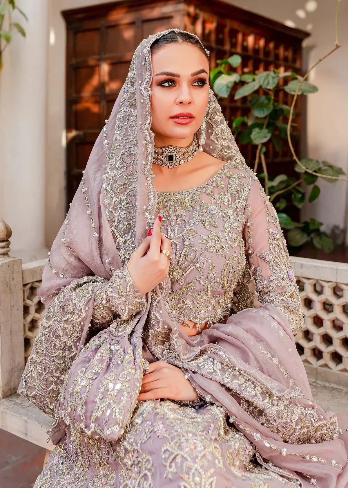 Kanwal Malik Zaarish lilac organza lehenga choli featuring heavy embroidery and hand embellishments with naqshi, dabka, crystals, pearls, and sequin in a blend of floral and geometrical patterns, paired with an organza dupatta adorned with a four-sided embellished border and vertical embellished lines at the center with extended pallu, perfect for weddings and formal occasions.