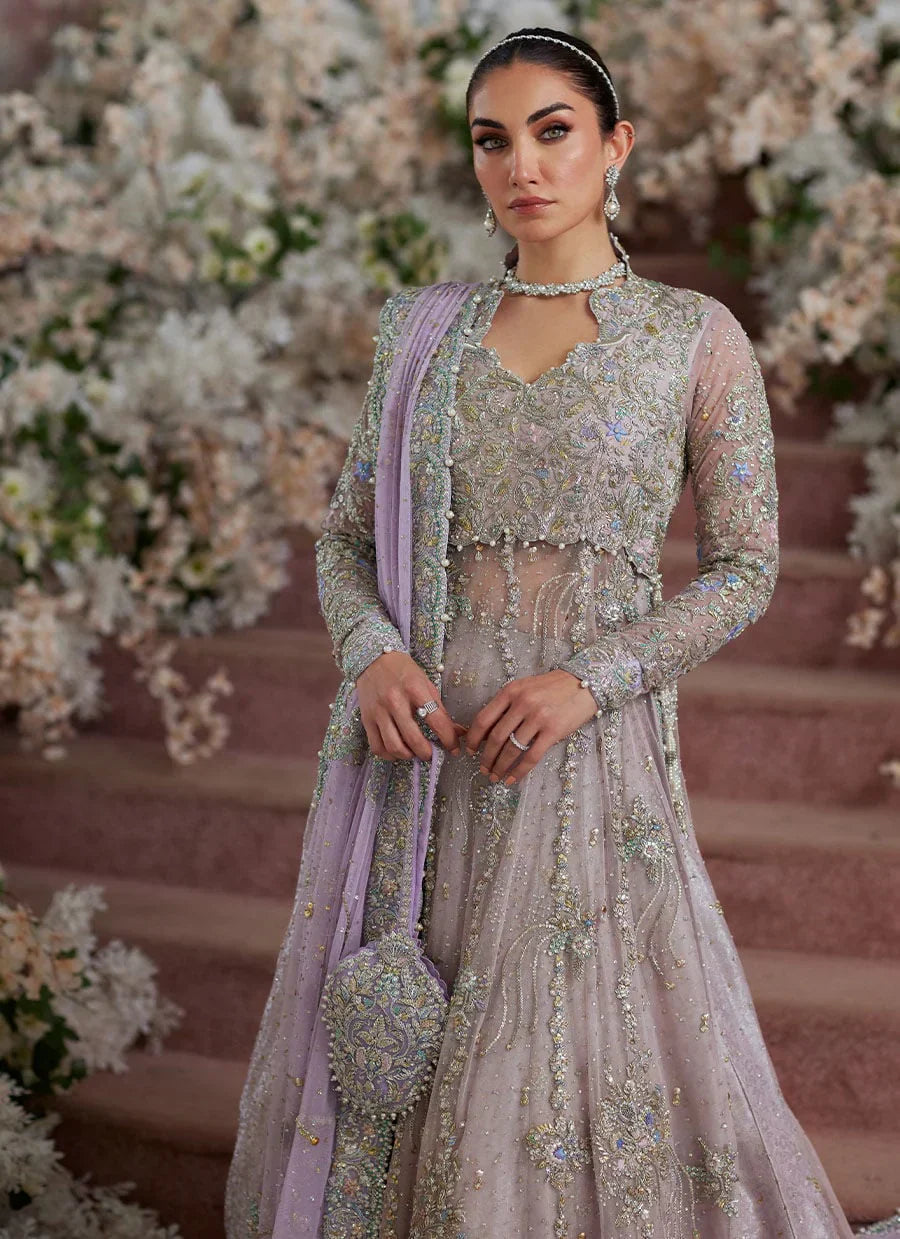 Farah Talib Aziz Elanur lilac bridal kalidaar crafted on pure net with intricate hand embellishments featuring a flared silhouette, paired with a classic lehenga and coordinated net dupatta with subtle embroidery, perfect for wedding festivities and formal celebrations.