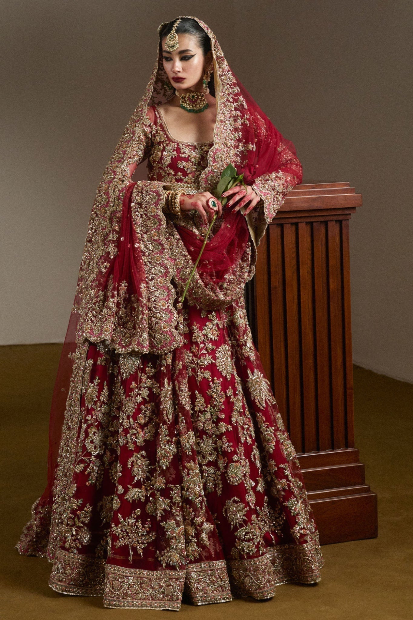 Hussain Rehar Qashqaye deep maroon lehenga choli featuring exquisite handwork that shimmers with delicate light, with a voluminous lehenga paired with an intricately worked choli, perfect for bridal wear and grand wedding celebrations.