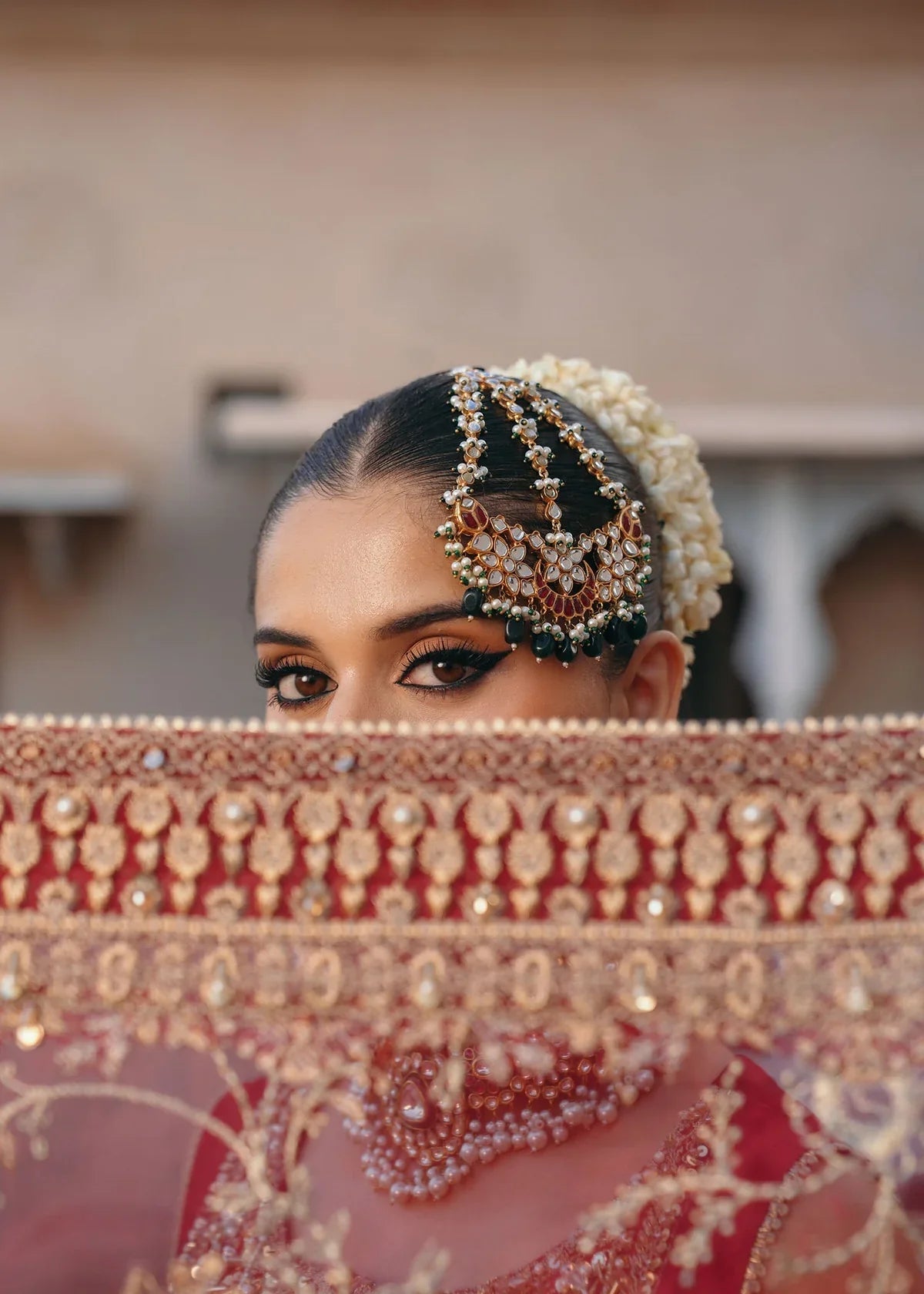 Mehek red ada embroidery Pakistani formal three-piece ensemble featuring a tissue silk shirt with a square neckline and intricate traditional embroidery, paired with matching tissue silk gharara and a kathan organza dupatta, perfect for weddings and festive celebrations.