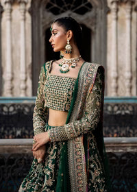  Kanwal Malik Sukhan bottle green net lehenga choli featuring an intricately embellished choli and flowing lehenga with a floral jaal design in vibrant orange and pink accents, enhanced with gold, gotta, and silver embellishments, complete with a matching net dupatta with an embellished border, perfect for weddings and festive occasions.