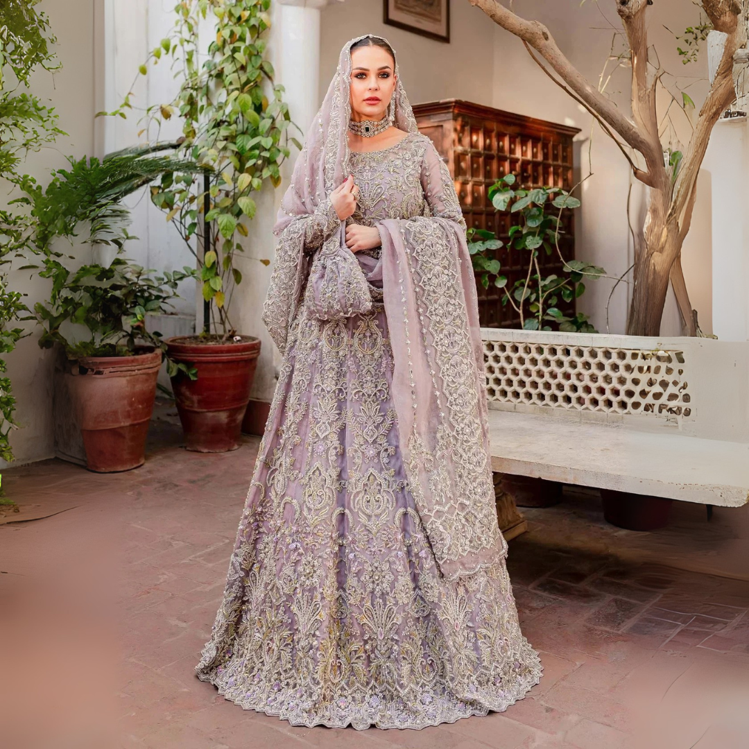 Kanwal Malik Zaarish lilac organza lehenga choli featuring heavy embroidery and hand embellishments with naqshi, dabka, crystals, pearls, and sequin in a blend of floral and geometrical patterns, paired with an organza dupatta adorned with a four-sided embellished border and vertical embellished lines at the center with extended pallu, perfect for weddings and formal occasions.