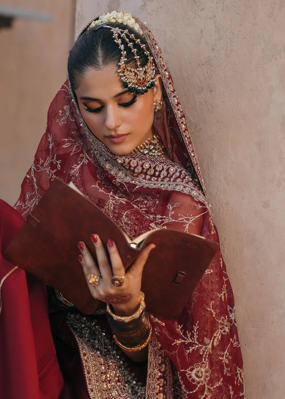 Mehek red ada embroidery Pakistani formal three-piece ensemble featuring a tissue silk shirt with a square neckline and intricate traditional embroidery, paired with matching tissue silk gharara and a kathan organza dupatta, perfect for weddings and festive celebrations.