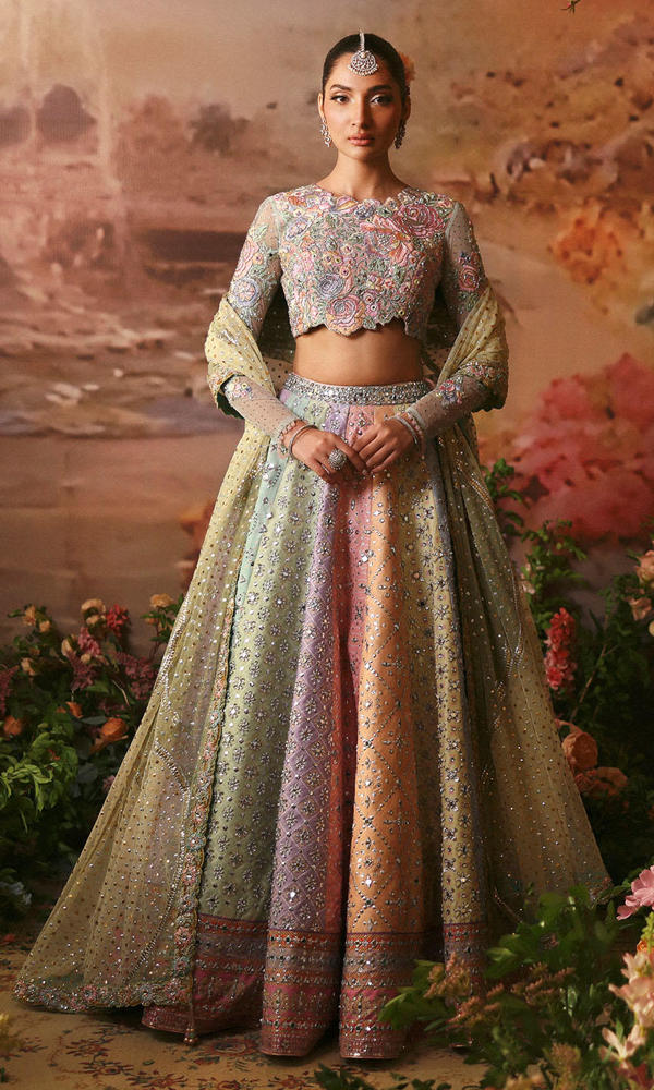 Nomi Ansari Fairytale pastel bridal lehenga choli featuring a harmonious blend of blush pink, powder blue, and pistachio tones with intricate hand embroidery, delicate zari work, and shimmering embellishments on a beautifully panelled lehenga with a finely embellished choli and a dreamy net dupatta with subtle detailing, perfect for valima, engagement, nikah, and reception events.