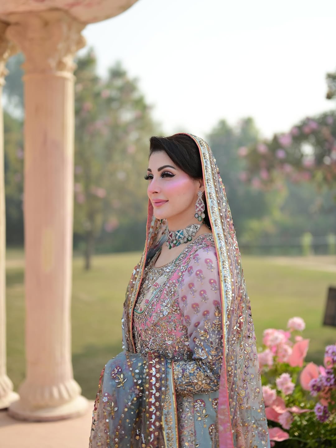 Nomi Ansari pastel princess-style lehenga choli inspired by Maryam Nawaz viral wedding look in soft blush pink and mint tones layered over a powder base, featuring delicate handcrafted embellishments with a floaty lightweight dupatta that creates a dreamy silhouette, perfect for valima receptions, engagement ceremonies, and bridesmaids