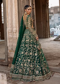  Kanwal Malik Sukhan bottle green net lehenga choli featuring an intricately embellished choli and flowing lehenga with a floral jaal design in vibrant orange and pink accents, enhanced with gold, gotta, and silver embellishments, complete with a matching net dupatta with an embellished border, perfect for weddings and festive occasions.