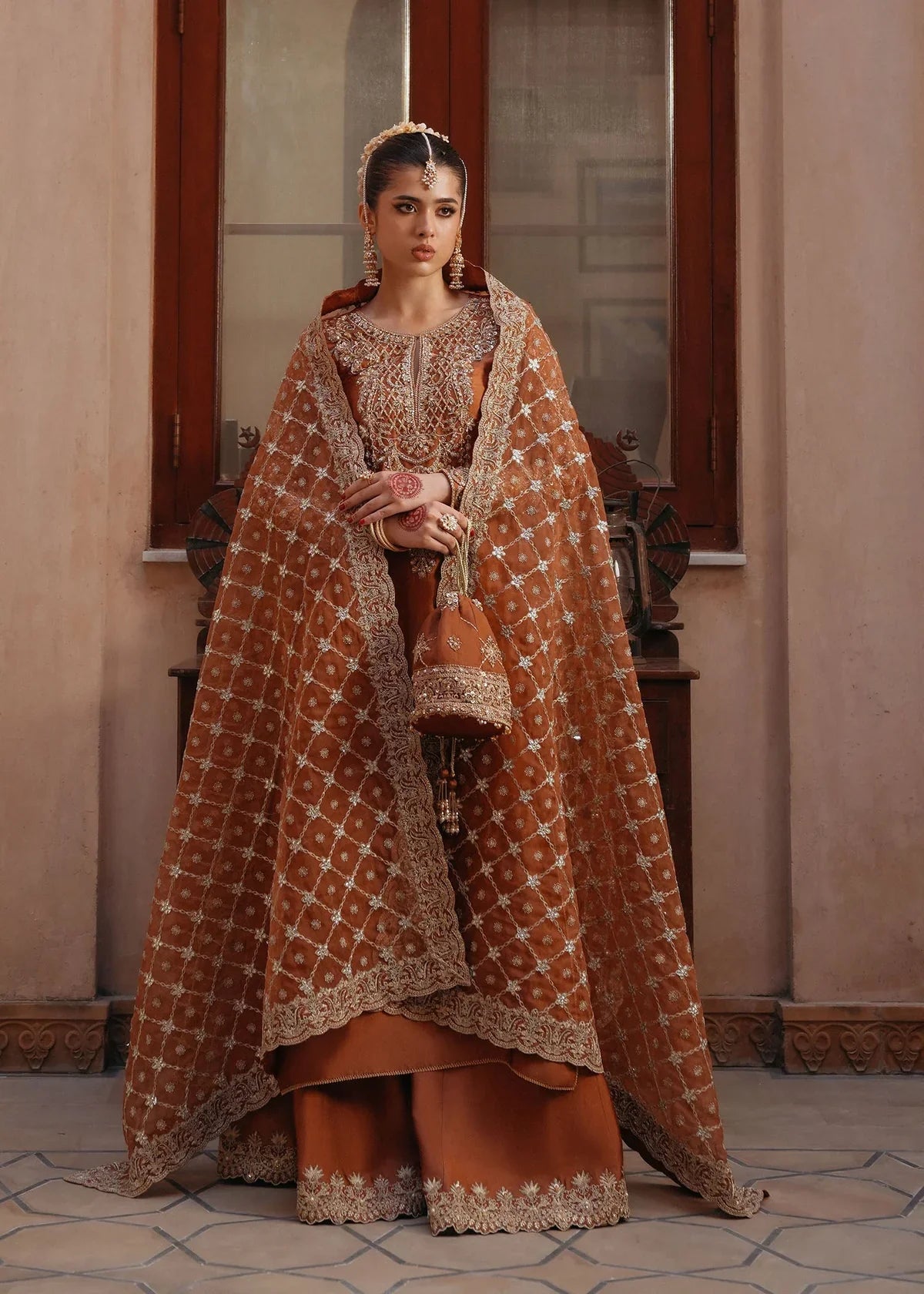  Zulekha Golden Mocha Pakistani formal three-piece ensemble featuring a long shirt in luxurious Korean silk with delicate embroidery on the neckline and sleeves, paired with matching flared trousers and a fully embroidered organza dupatta, perfect for festive evenings and elegant gatherings.