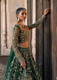  Kanwal Malik Sukhan bottle green net lehenga choli featuring an intricately embellished choli and flowing lehenga with a floral jaal design in vibrant orange and pink accents, enhanced with gold, gotta, and silver embellishments, complete with a matching net dupatta with an embellished border, perfect for weddings and festive occasions.